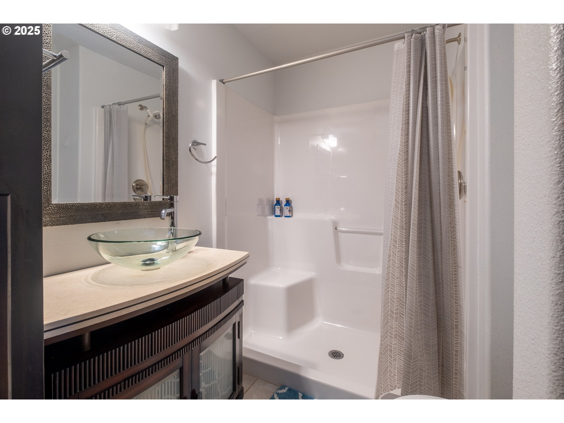 760 Southwest Range Drive Waldport, OR 97394 - Photo 26 of 30 a bathroom with a sink a mirror a vanity and a shower