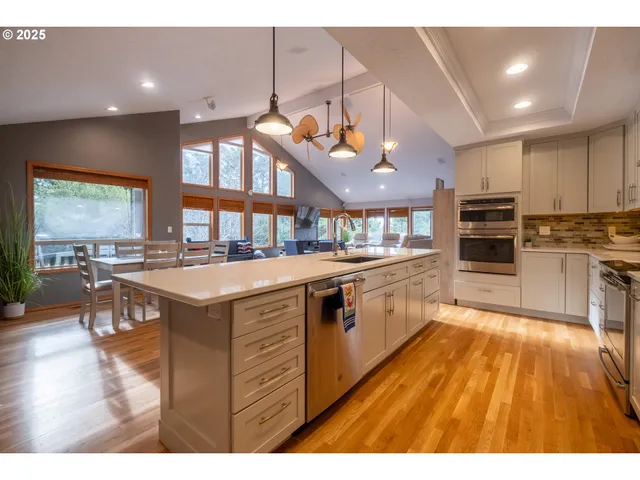 a kitchen with stainless steel appliances granite countertop a stove and a refrigerator