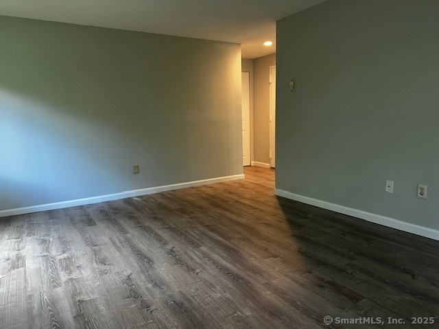 7 Padanaram Road, Unit J232 Danbury, CT 06811 - Photo 11 of 26 a view of an empty room with wooden floor and a window