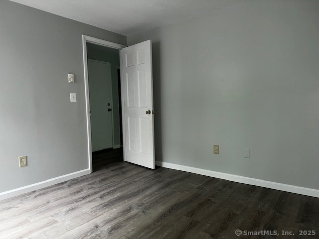 7 Padanaram Road, Unit J232 Danbury, CT 06811 - Photo 14 of 26 a view of an empty room with wooden floor and closet