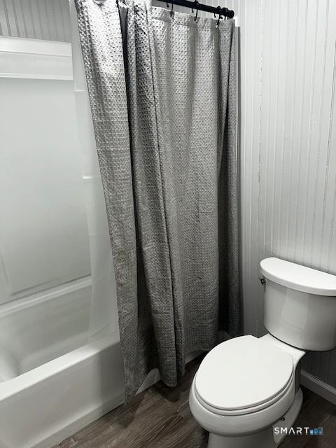 7 Padanaram Road, Unit J232 Danbury, CT 06811 - Photo 18 of 26 a white toilet sitting next to a bath tub