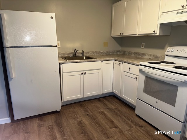7 Padanaram Road, Unit J232 Danbury, CT 06811 - Photo 2 of 26 a white refrigerator freezer sitting inside of a kitchen