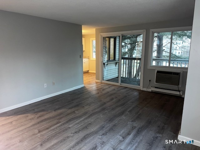 7 Padanaram Road, Unit J232 Danbury, CT 06811 - Photo 25 of 26 a view of a livingroom with wooden floor and fireplace