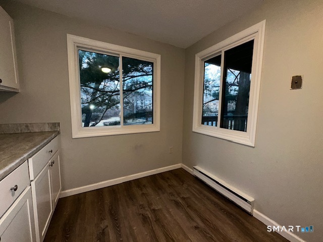 7 Padanaram Road, Unit J232 Danbury, CT 06811 - Photo 4 of 26 an empty room with wooden floor and windows