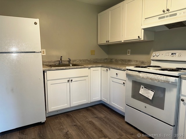 7 Padanaram Road, Unit J232 Danbury, CT 06811 - Photo 7 of 26 a kitchen with granite countertop white cabinets and white appliances