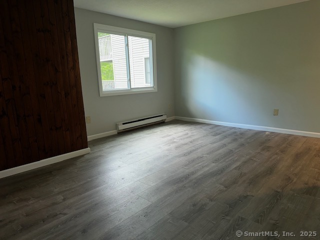 7 Padanaram Road, Unit J232 Danbury, CT 06811 - Photo 10 of 26 an empty room with wooden floor and windows