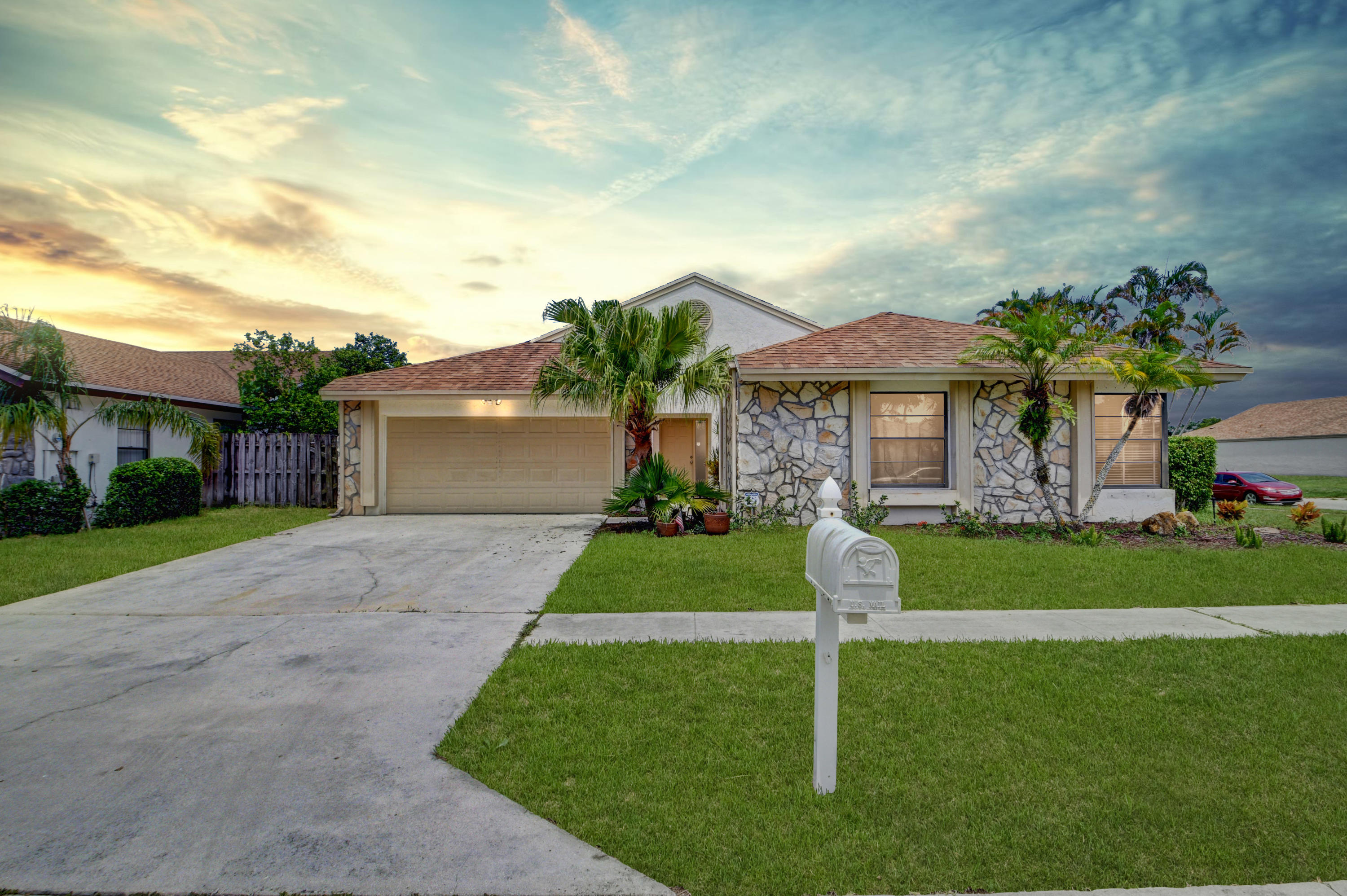 21080 Windemere Lane Boca Raton, FL 33428 - Photo 2 of 97 a front view of a house with a yard and garage