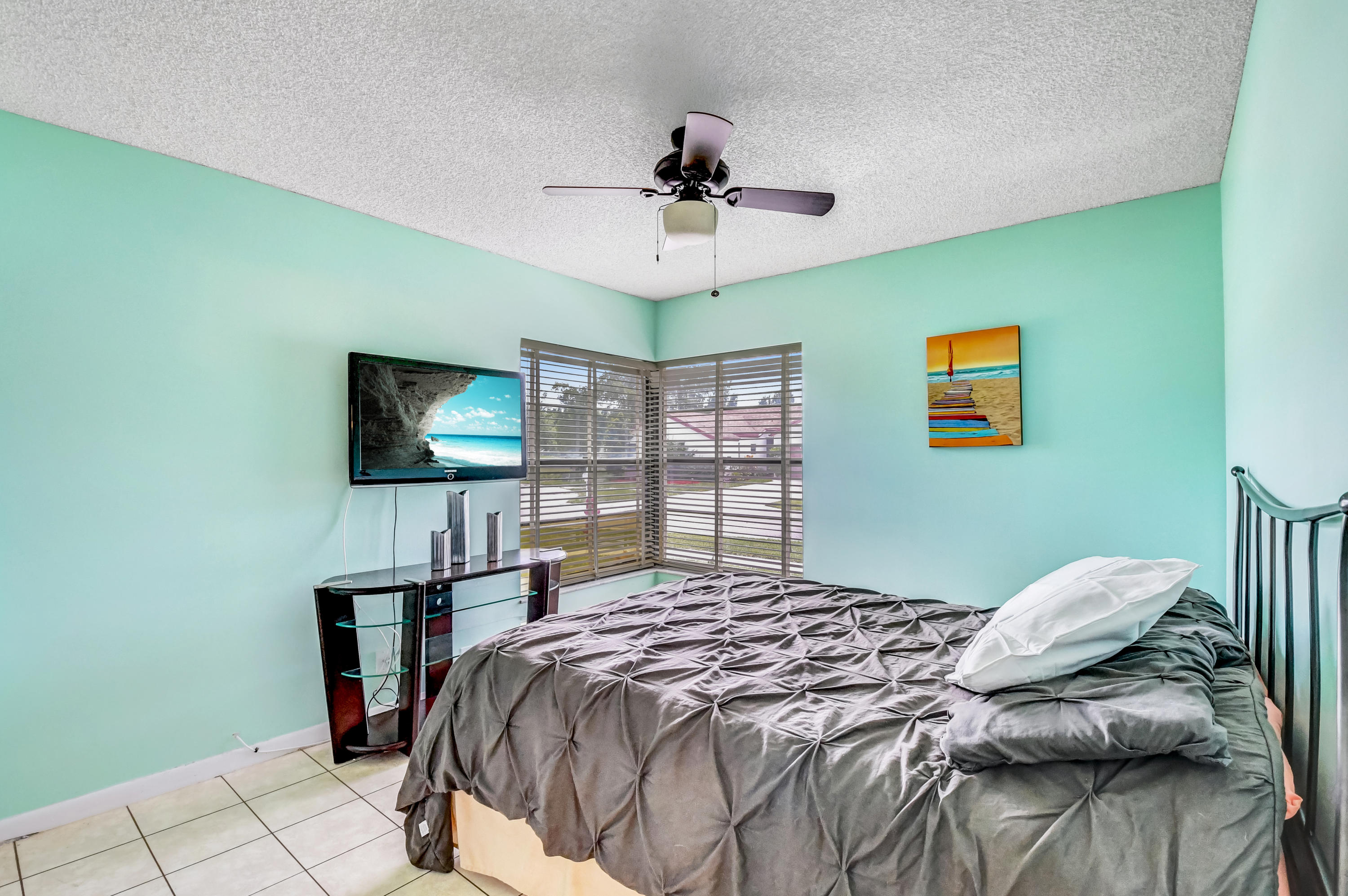 21080 Windemere Lane Boca Raton, FL 33428 - Photo 38 of 97 a bedroom with a bed and a flat screen tv