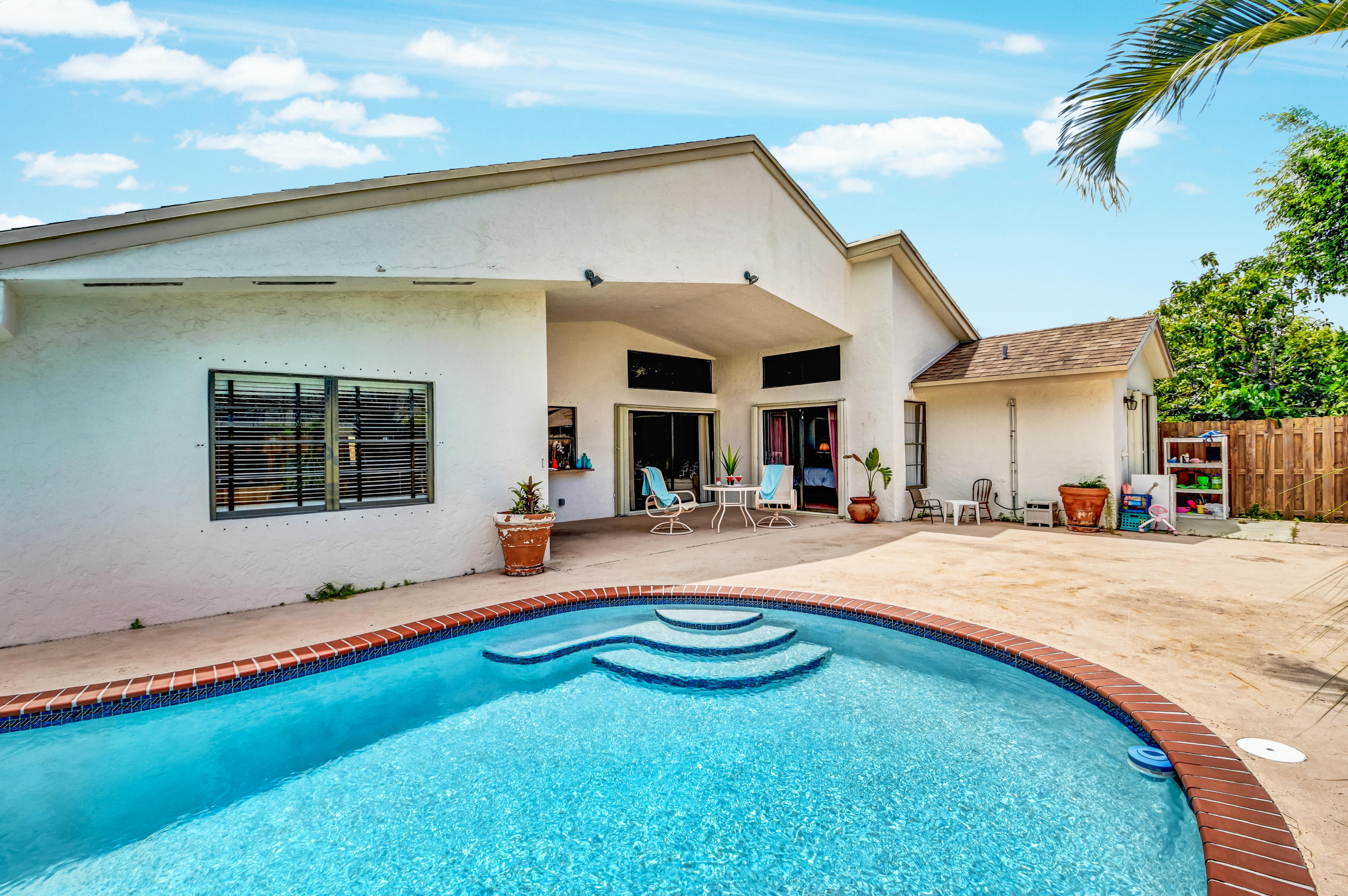 21080 Windemere Lane Boca Raton, FL 33428 - Photo 55 of 97 a swimming pool with outdoor seating and yard