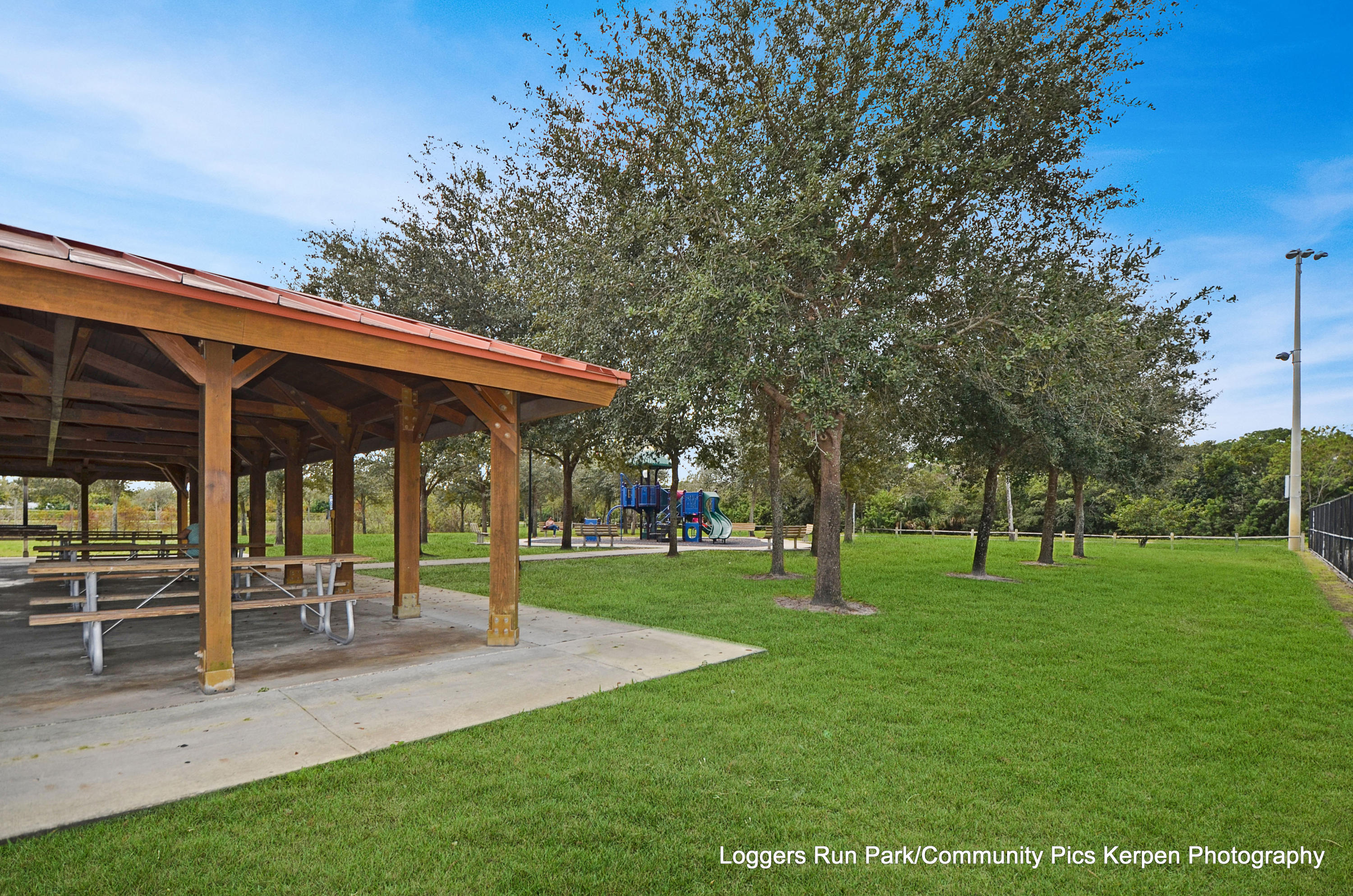 21080 Windemere Lane Boca Raton, FL 33428 - Photo 84 of 97 a view of a park with swings and a table and chairs