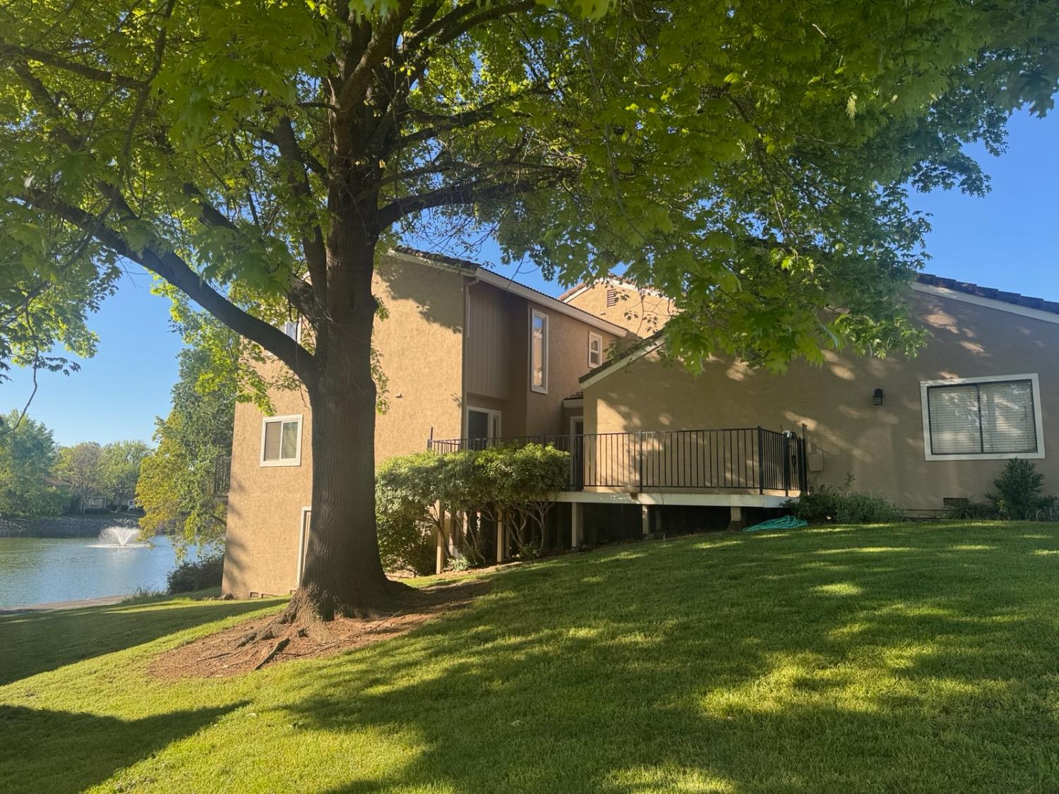 a backyard of a house with table and chairs