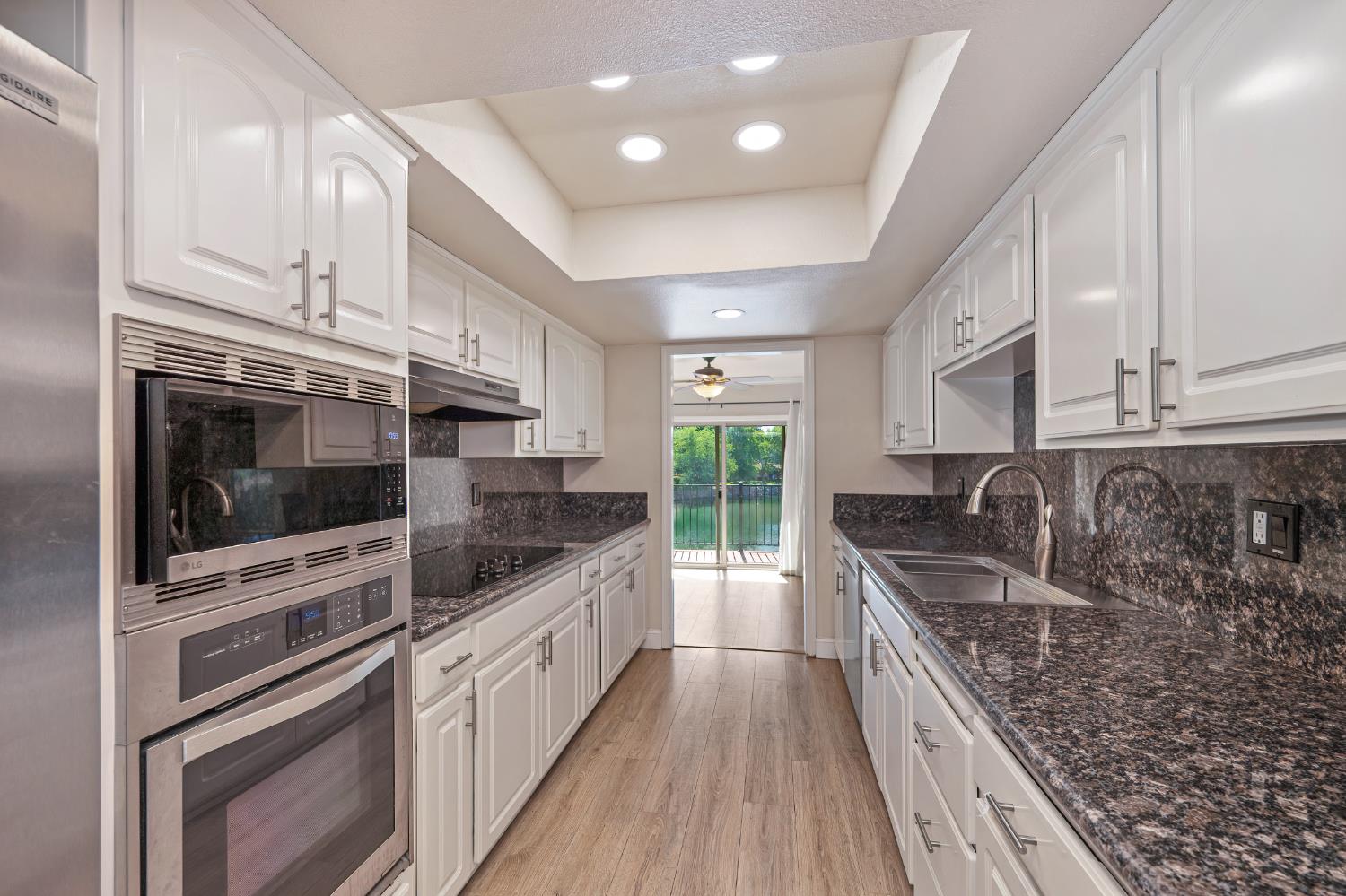6986 Carreta Lane Rancho Murieta, CA 95683 - Photo 15 of 47 a kitchen with stainless steel appliances granite countertop a stove and a sink