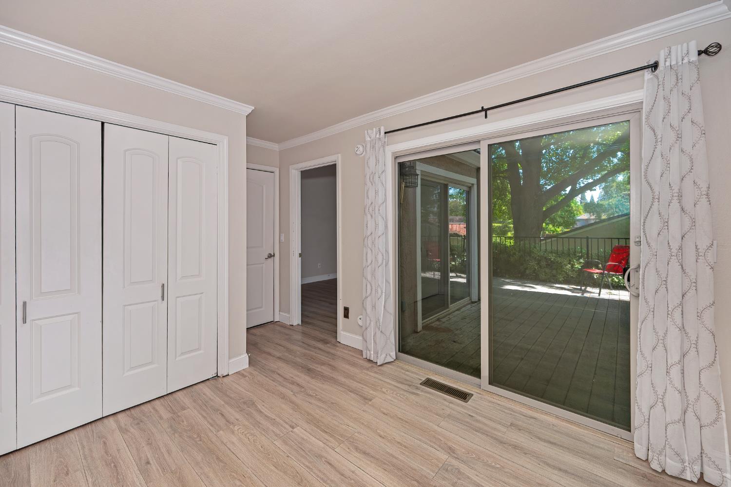 6986 Carreta Lane Rancho Murieta, CA 95683 - Photo 16 of 47 a view of empty room with wooden floor and fan