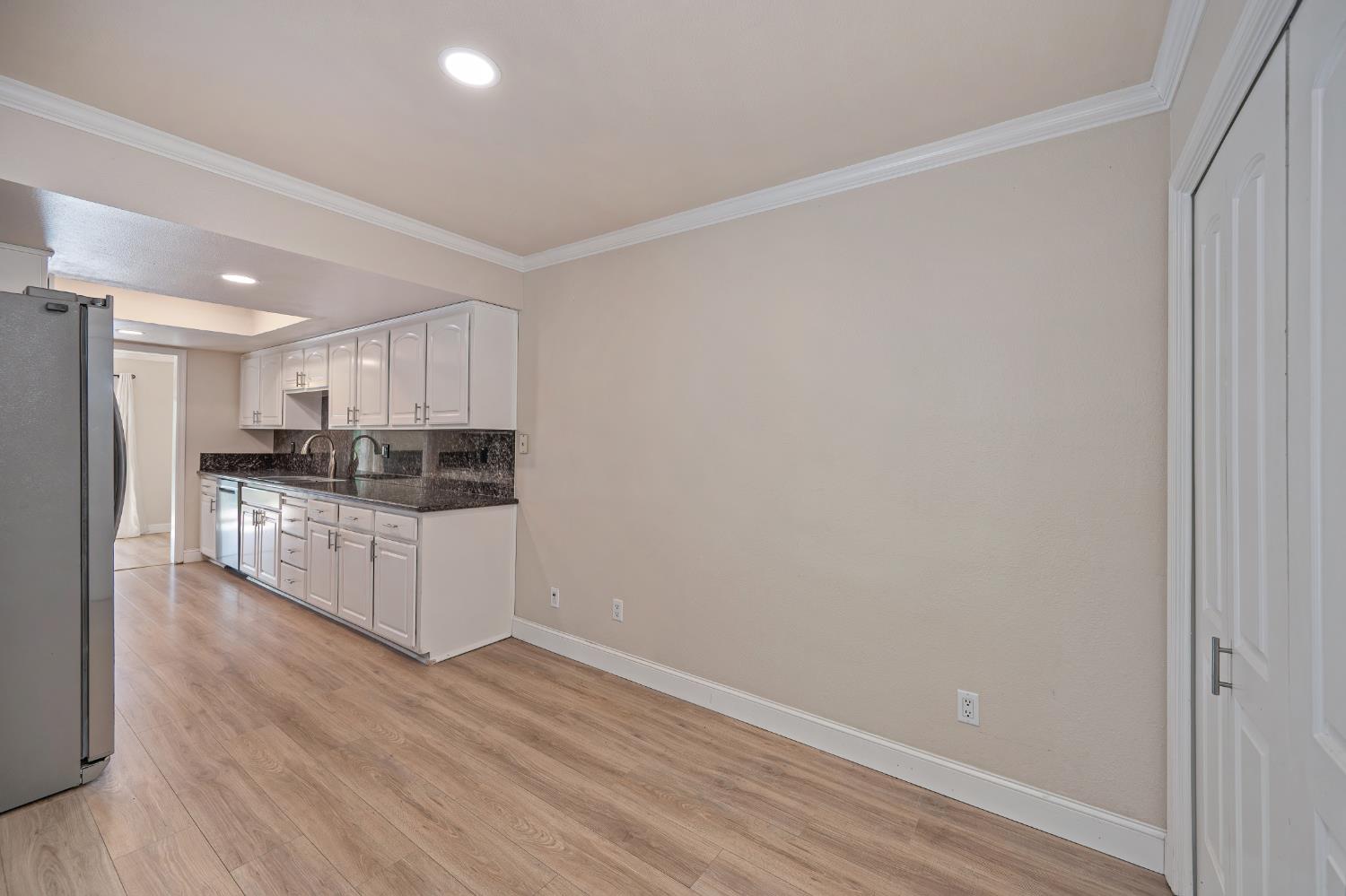 6986 Carreta Lane Rancho Murieta, CA 95683 - Photo 17 of 47 a kitchen with stainless steel appliances wooden floor and window