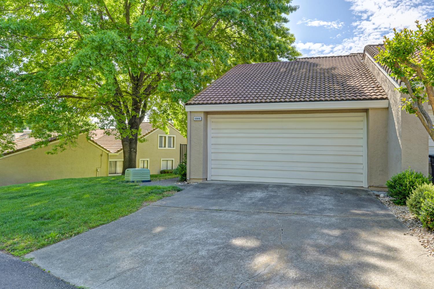 6986 Carreta Lane Rancho Murieta, CA 95683 - Photo 4 of 47 a front view of a house with a yard and garage
