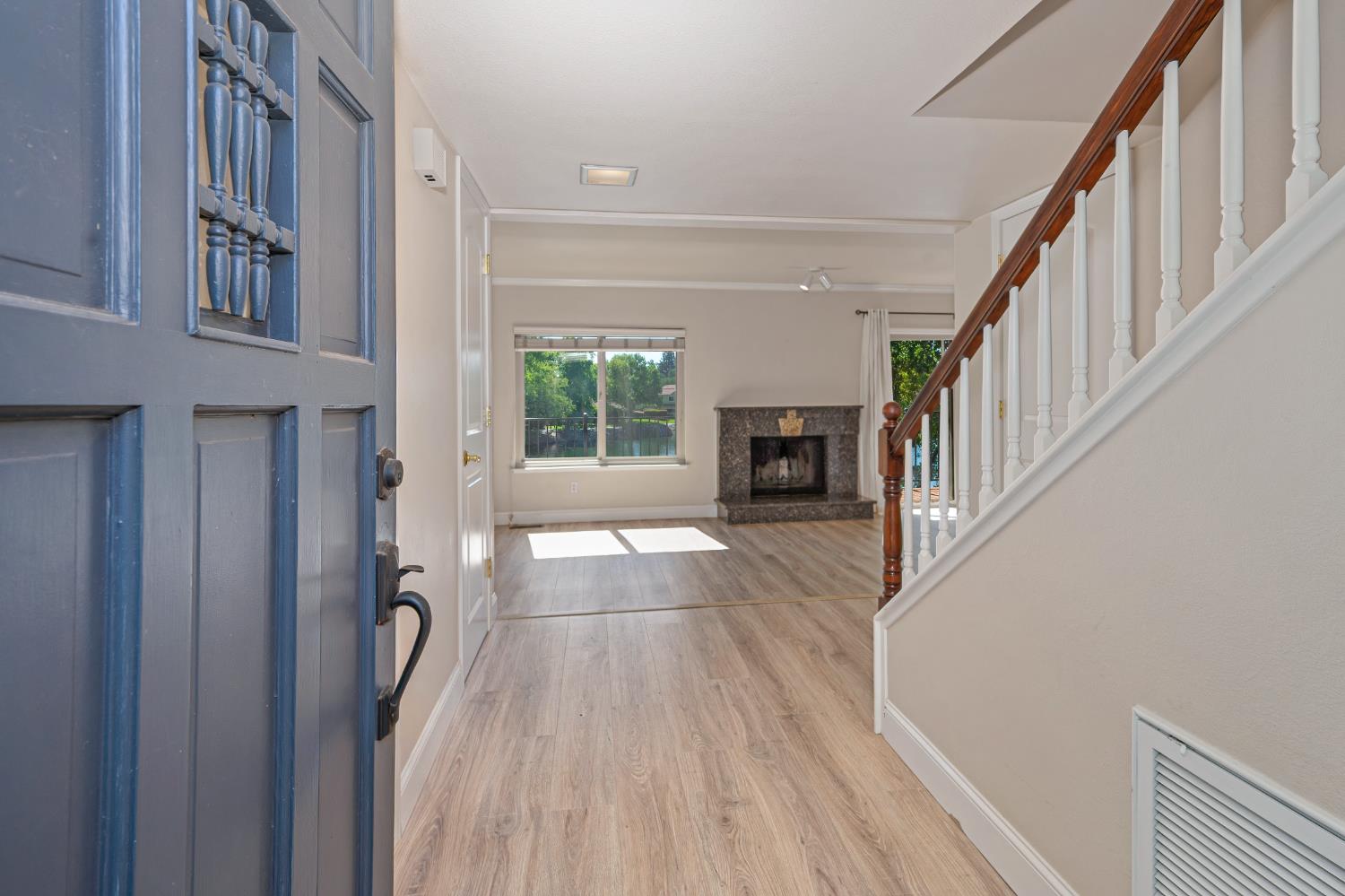 6986 Carreta Lane Rancho Murieta, CA 95683 - Photo 6 of 47 a view of an entryway with wooden floor and a livingroom
