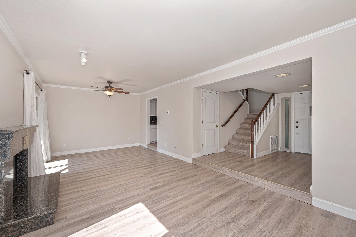 6986 Carreta Lane Rancho Murieta, CA 95683 - Photo 9 of 47 a view of empty room with wooden floor and fireplace