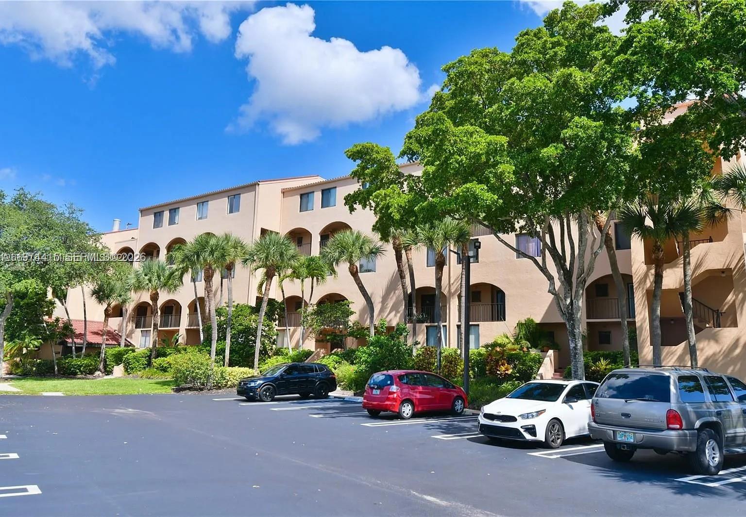 755 Dotterel Road, Unit 1301 Delray Beach, FL 33444 - Photo 1 of 15 a car parked in front of a building with small yard