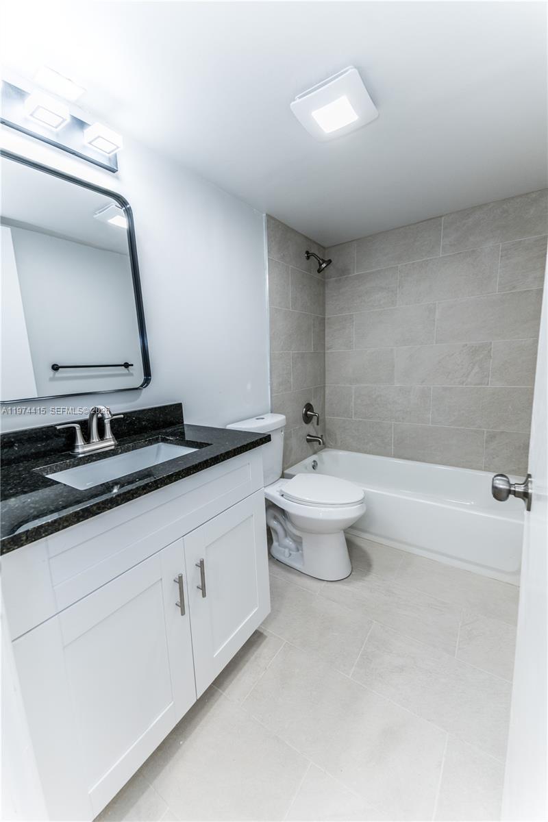 755 Dotterel Road, Unit 1301 Delray Beach, FL 33444 - Photo 9 of 15 a bathroom with a double vanity sink and a mirror