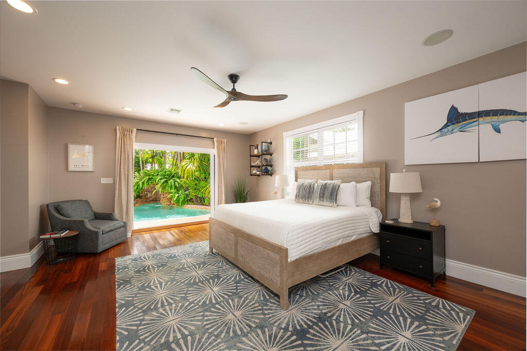 1320 South Street Key West, FL 33040 - Photo 16 of 36 a spacious bedroom with a bed and a chair