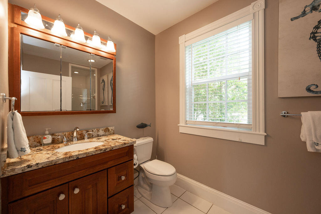 1320 South Street Key West, FL 33040 - Photo 17 of 36 a bathroom with a granite countertop toilet sink and mirror