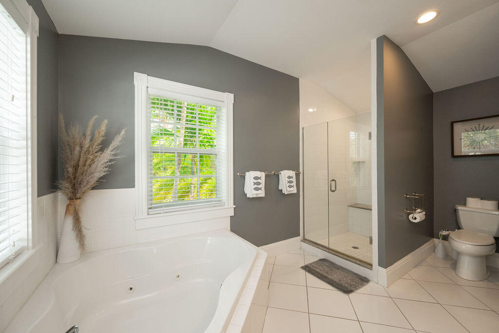 1320 South Street Key West, FL 33040 - Photo 20 of 36 a spacious bathroom with a bathtub and a shower