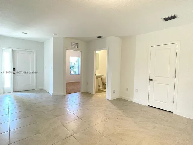 a view of a big room with windows and bathroom