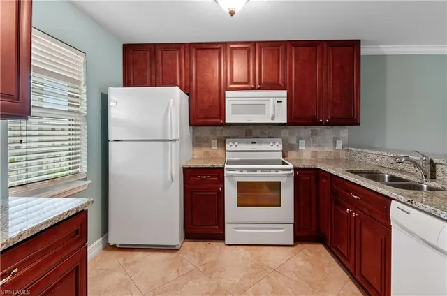a kitchen with a refrigerator sink stove and cabinets
