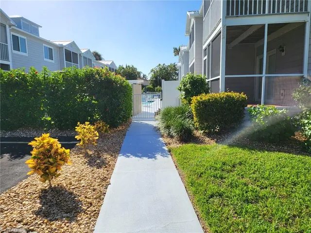 a view of a house with pool porch and sitting area