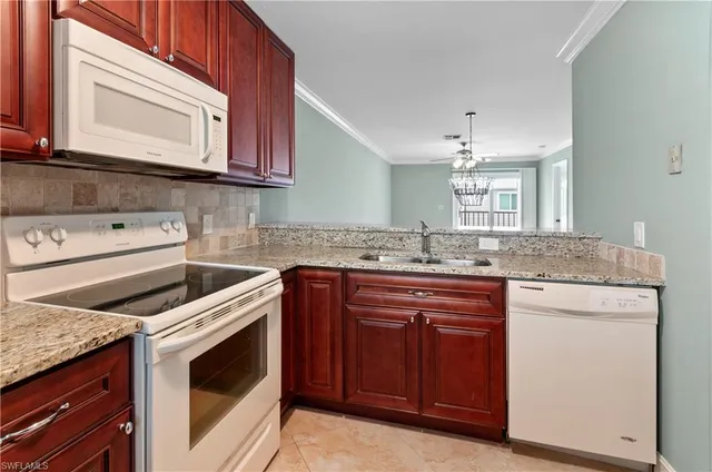 a kitchen with granite countertop cabinets stainless steel appliances and a sink