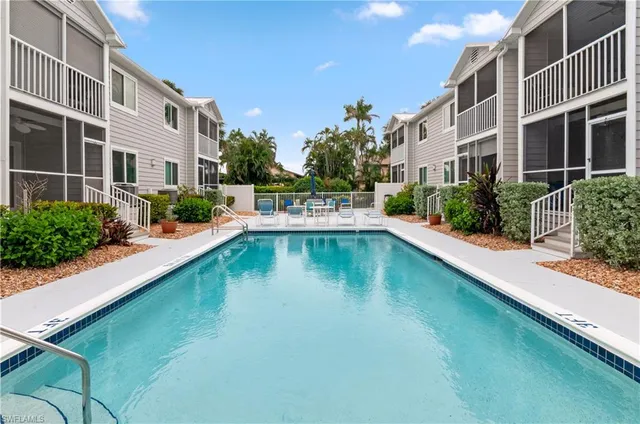 a swimming pool with outdoor seating and yard