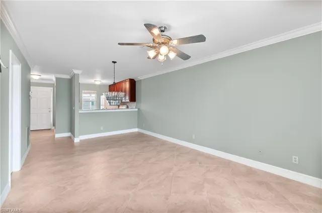 a view of a kitchen with a sink and a chandelier fan