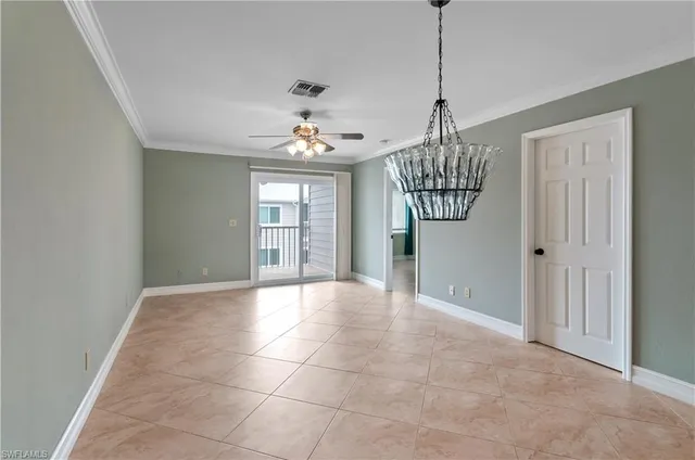 a view of livingroom with chandelier and kitchen view