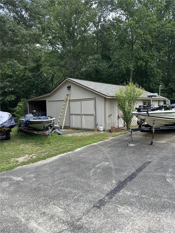 5565 Hog Mountain Road Flowery Branch, GA 30542 - Photo 2 of 5 a view of a house with backyard and porch