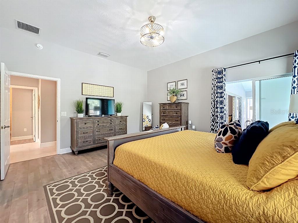 3191 Warbler Loop The Villages, FL 32163 - Photo 17 of 42 a bedroom with a bed a couch and dresser