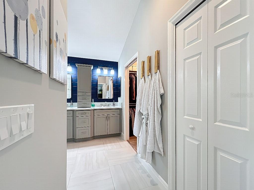 3191 Warbler Loop The Villages, FL 32163 - Photo 19 of 42 a bathroom with a double vanity sink and a mirror