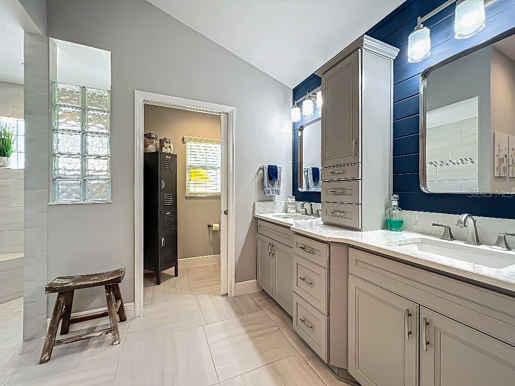 3191 Warbler Loop The Villages, FL 32163 - Photo 20 of 42 a spacious bathroom with a double vanity sink and a mirror