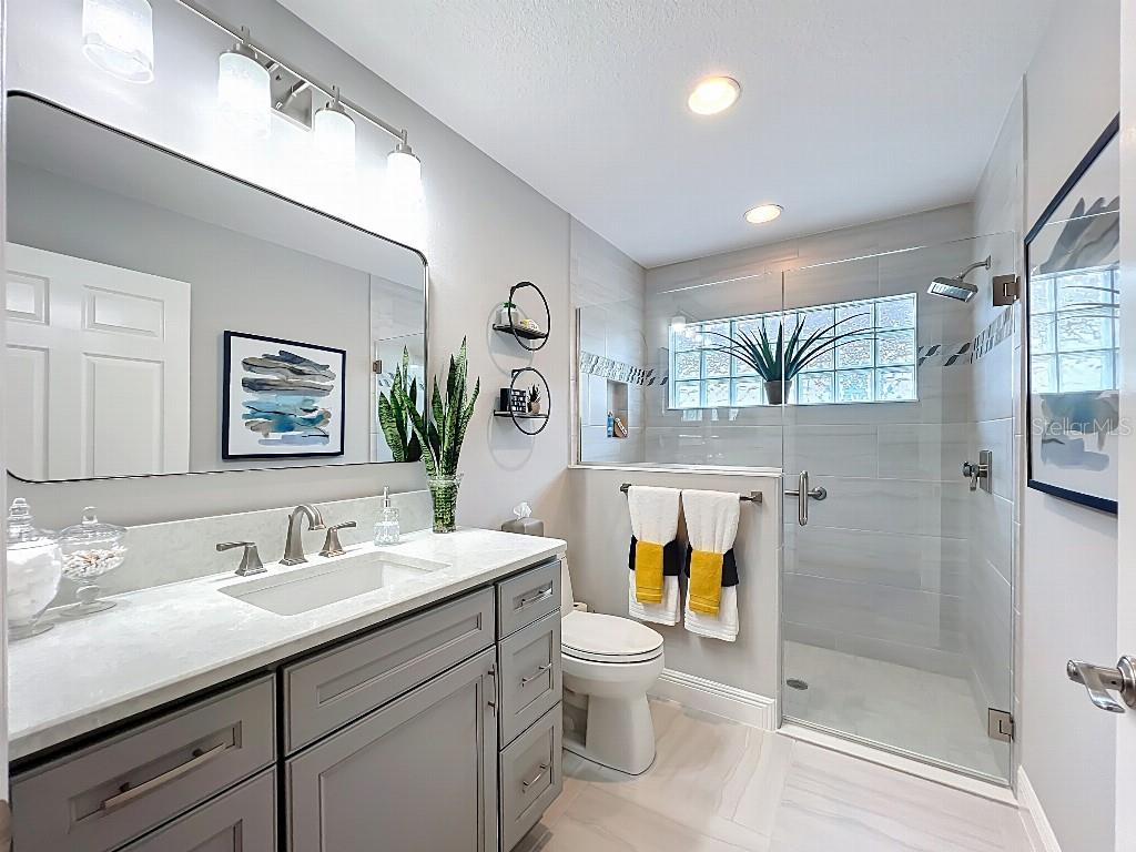 3191 Warbler Loop The Villages, FL 32163 - Photo 29 of 42 a bathroom with a granite countertop toilet sink and mirror