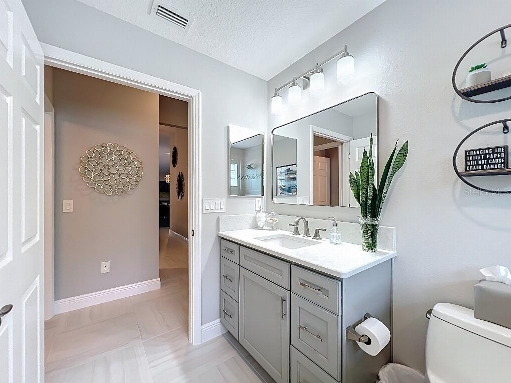 3191 Warbler Loop The Villages, FL 32163 - Photo 30 of 42 a bathroom with a toilet sink and mirror