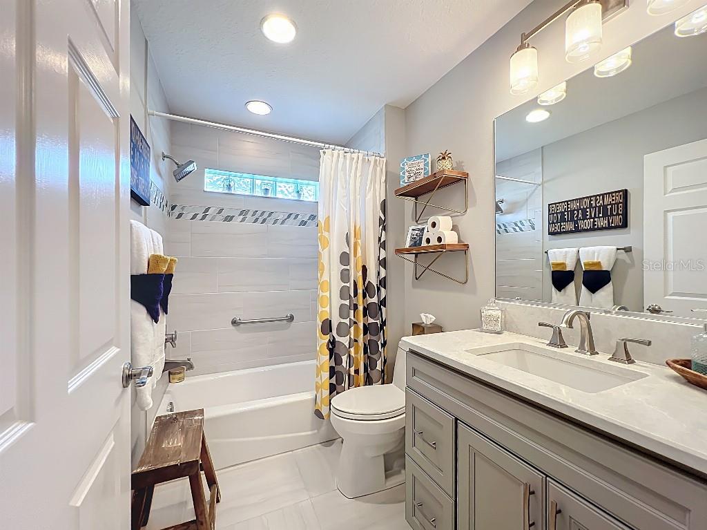 3191 Warbler Loop The Villages, FL 32163 - Photo 34 of 42 a bathroom with a granite countertop sink toilet and shower