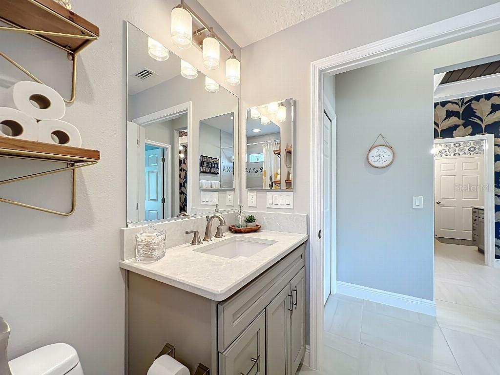 3191 Warbler Loop The Villages, FL 32163 - Photo 35 of 42 a bathroom with a sink a toilet and shower