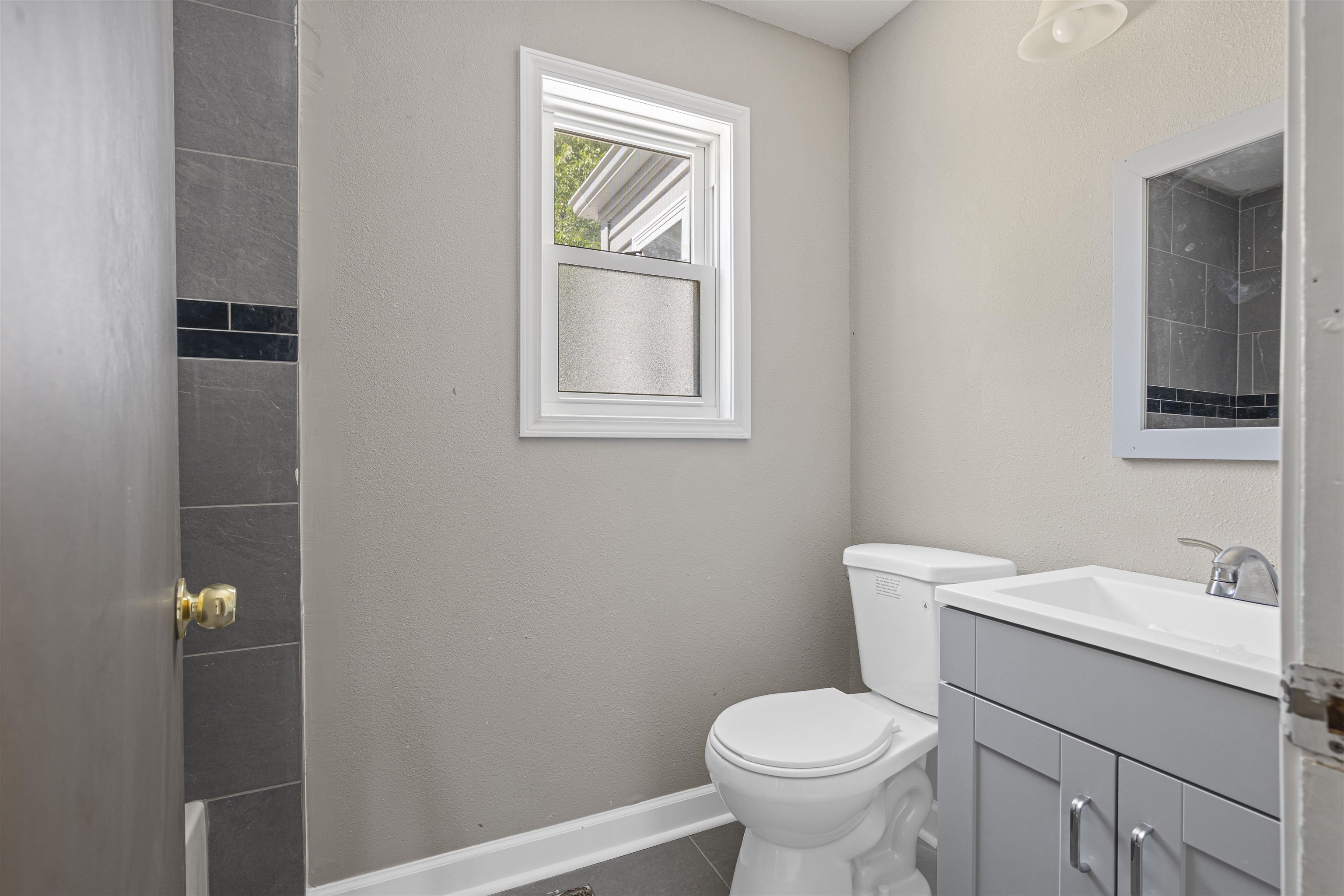 220 South Alpine Road Rockford, IL 61108 - Photo 11 of 18 a white toilet sitting next to a bathroom sink