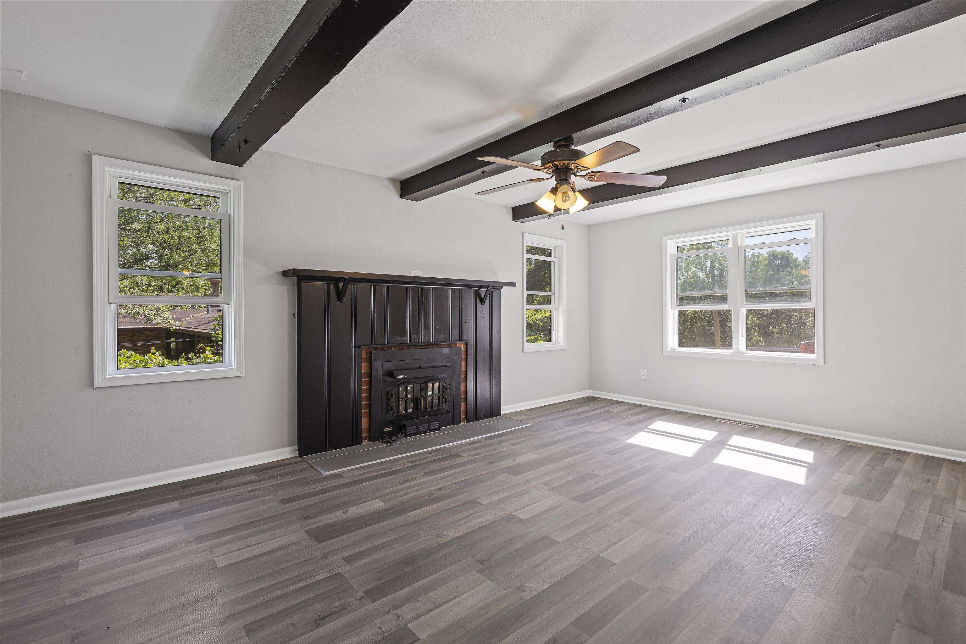 220 South Alpine Road Rockford, IL 61108 - Photo 3 of 18 an empty room with windows fireplace and wooden floor