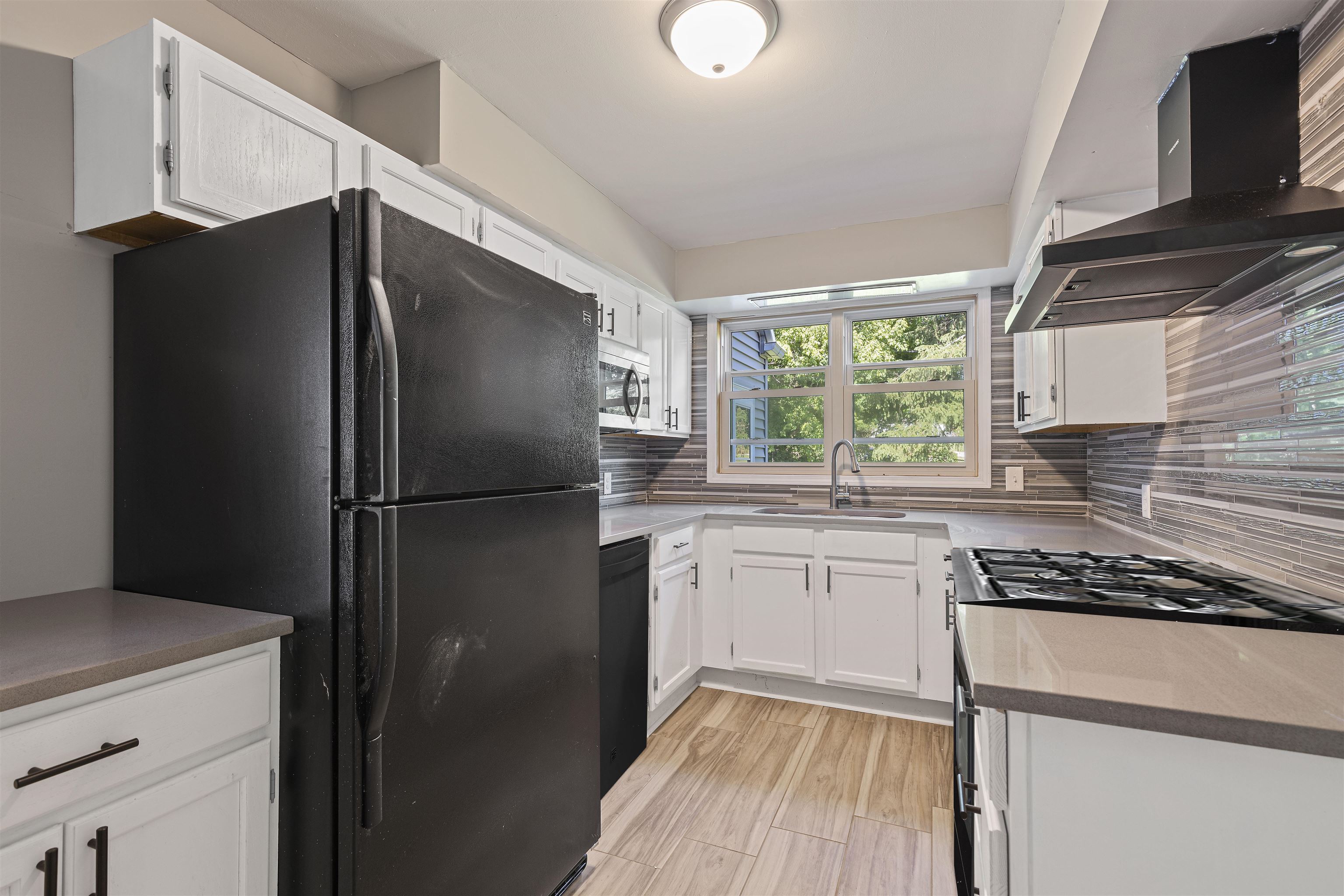 220 South Alpine Road Rockford, IL 61108 - Photo 7 of 18 a kitchen with stainless steel appliances granite countertop a refrigerator and a sink
