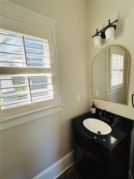 1021 Avery Road Canton, GA 30115 - Photo 18 of 70 a bathroom with a sink and a mirror