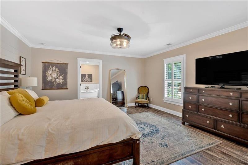 1021 Avery Road Canton, GA 30115 - Photo 23 of 70 a bedroom with a bed and a flat screen tv