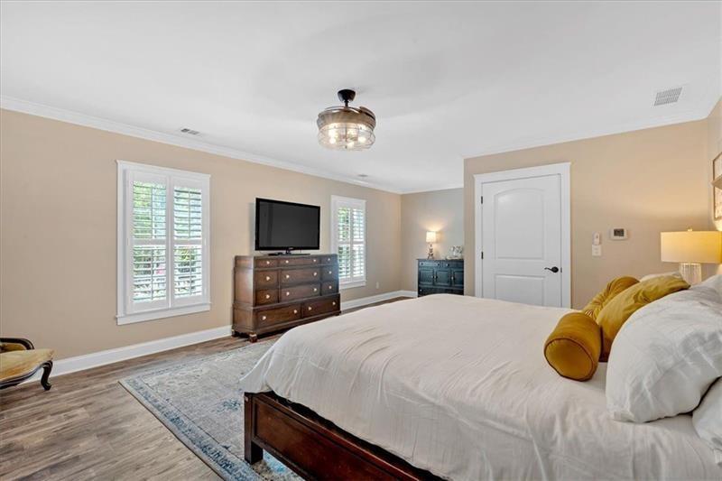 1021 Avery Road Canton, GA 30115 - Photo 24 of 70 a bedroom with a bed and a flat screen tv