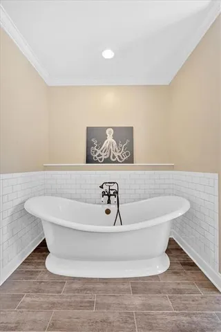 a spacious bedroom with a large bed and a chandelier