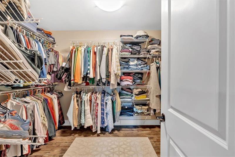 1021 Avery Road Canton, GA 30115 - Photo 29 of 70 a view of walk in closet with clothes and shoes