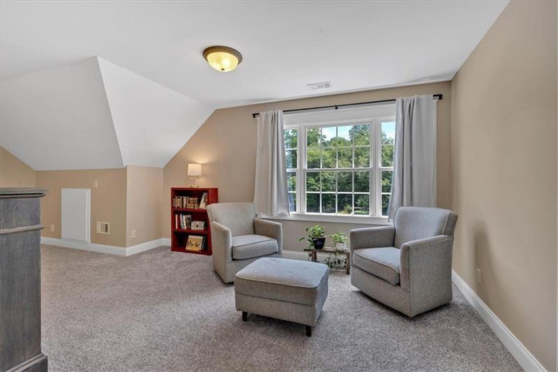 1021 Avery Road Canton, GA 30115 - Photo 30 of 70 a living room with furniture and a window